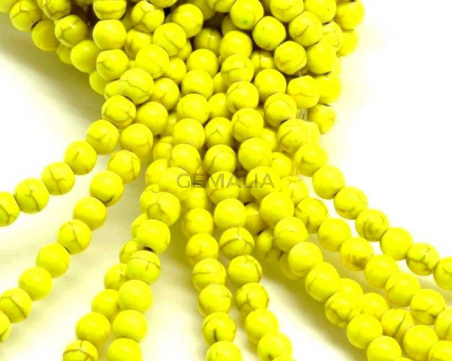 Turquesa sintetica.Bola 6mm.Amarillo fluor.Int.1mm aprox.
