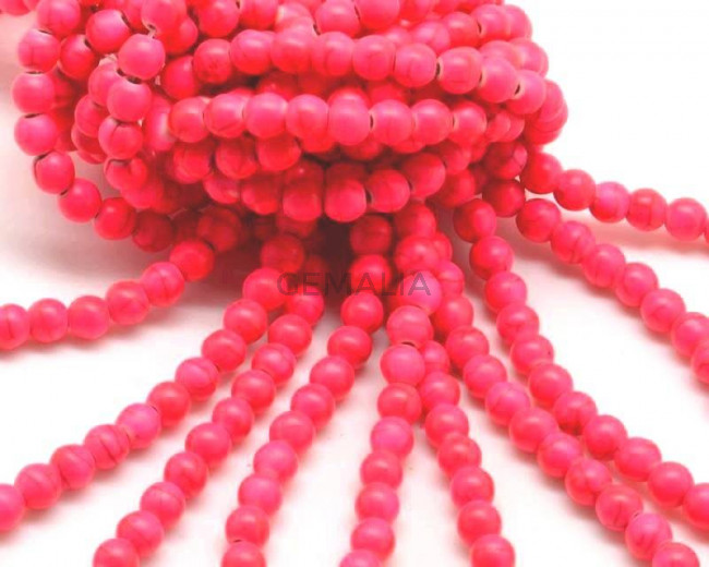 Turquesa sintetica.Bola 6mm.Fucsia fluor 2.Int.1mm aprox.