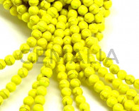 Turquesa sintetica.Bola 6mm.Amarillo fluor.Int.1mm aprox.
